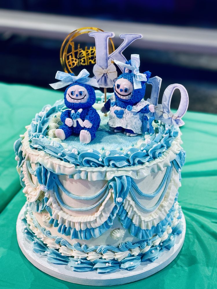 Vintage Labubu inspired cake with cakepop fondant figurines. 